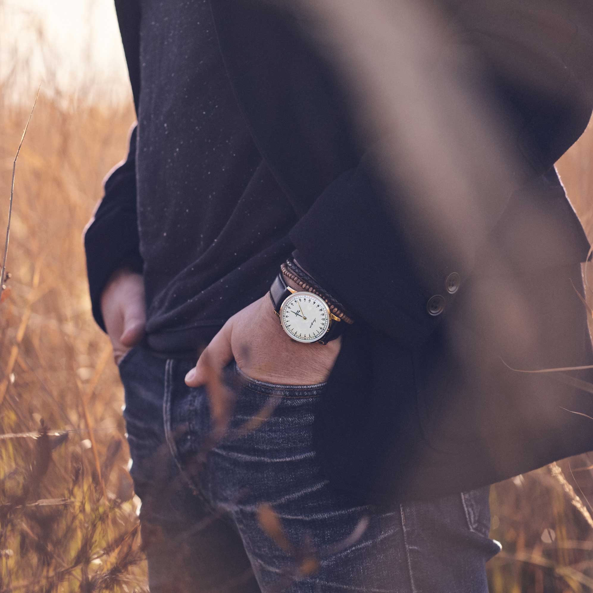 24-hour watch with gold case and black leather strap